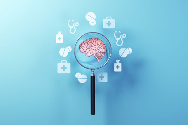 Human Brain Protection Concept with Medical Icons and metallic magnifying glass on soft blue background