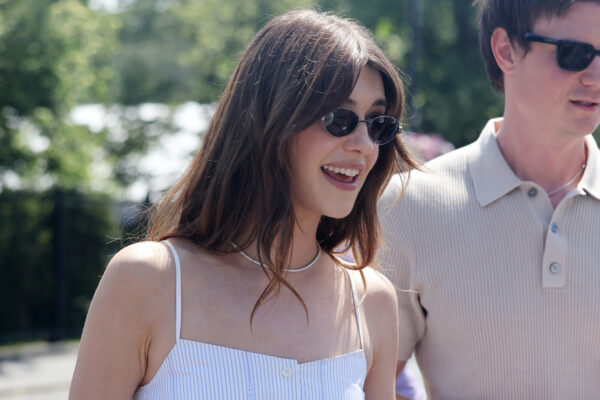 Daisy Edgar wears a matching linen set and carries a Gucci straw bag at Wimbledon