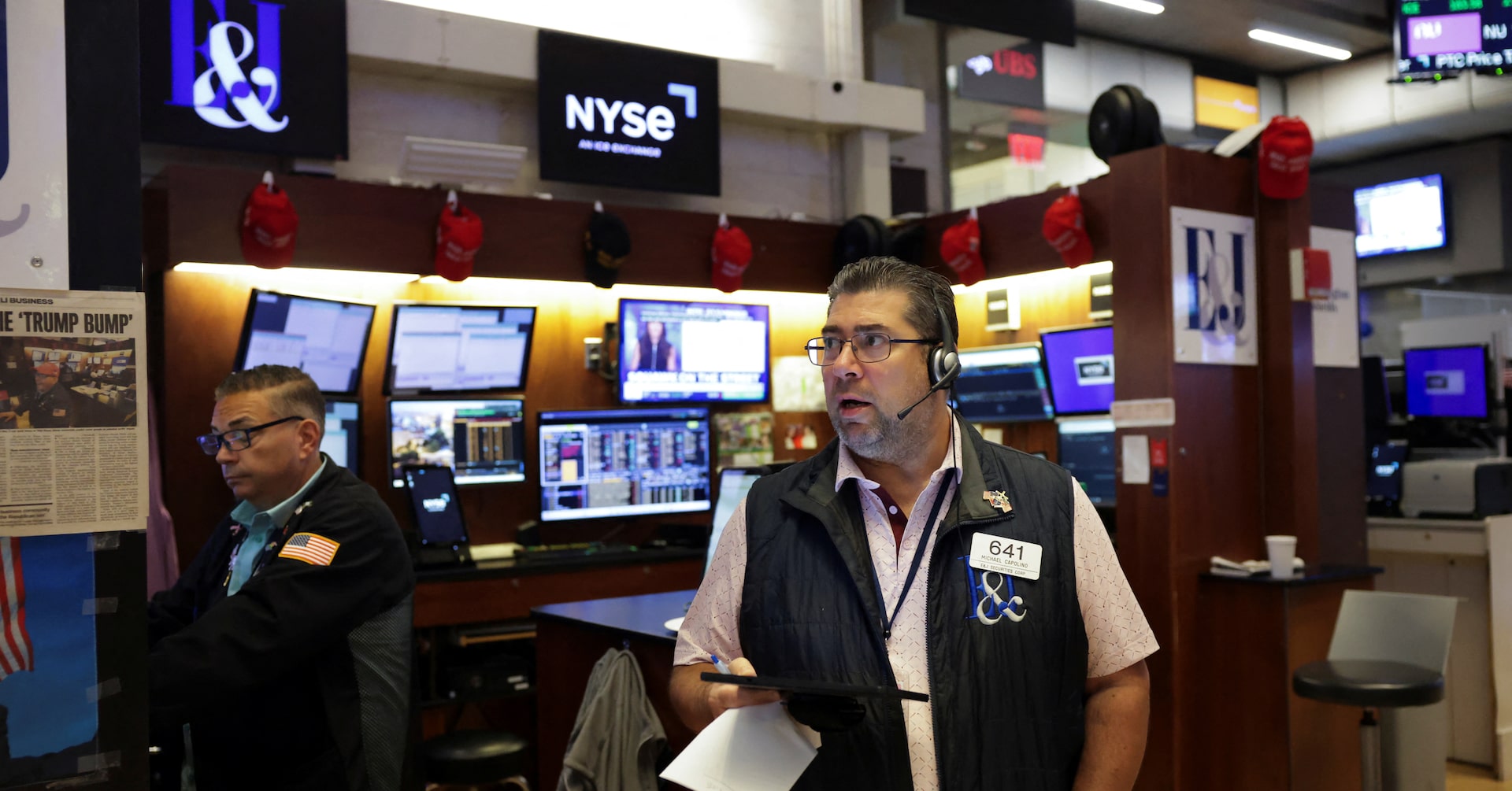Wall Street ends higher, dollar firms ahead of a big week for market risk