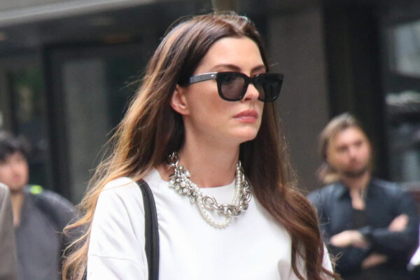 Anne Hathaway films The Devil Wears Prada 2 wearing white pants and a white top and carrying a vintage Coach briefcase