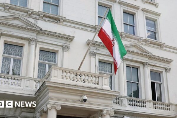 A flag flies in front of Iran's embassy, in London