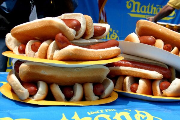 What does a hot dog eating contest do to your stomach? Experts detail the health effects of competitive eating.