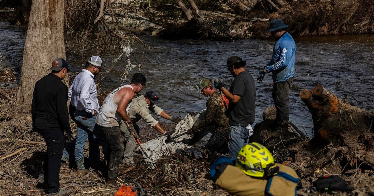Rescuers in Texas painstakingly pick through debris after deadly flooding