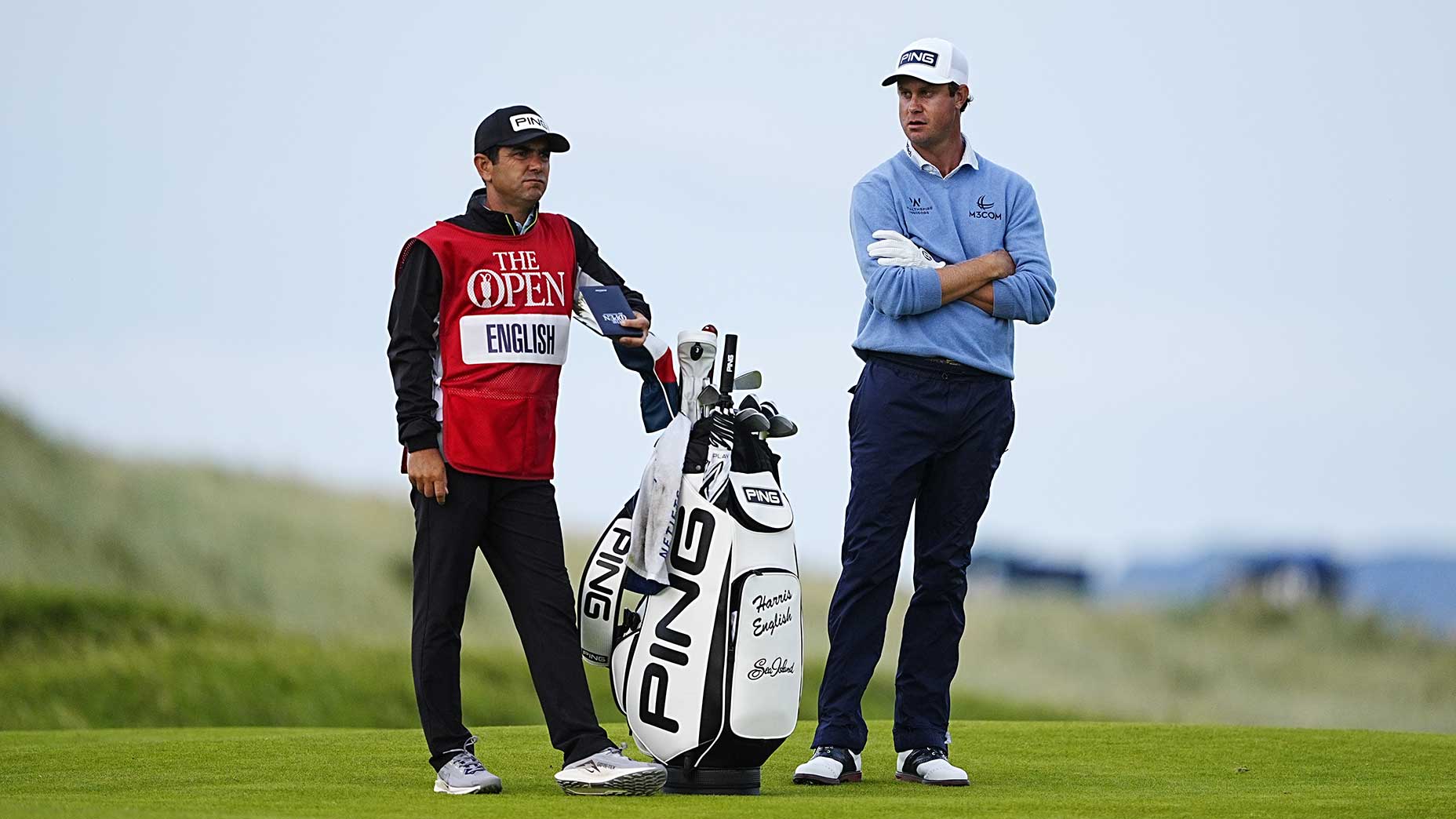 His caddie was denied entry into the U.K. He co-leads The Open anyway