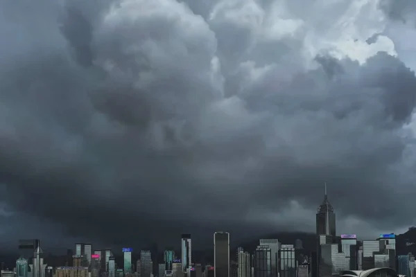 Dark storm clouds looming over the Hong Kong skyline before a typhoon.