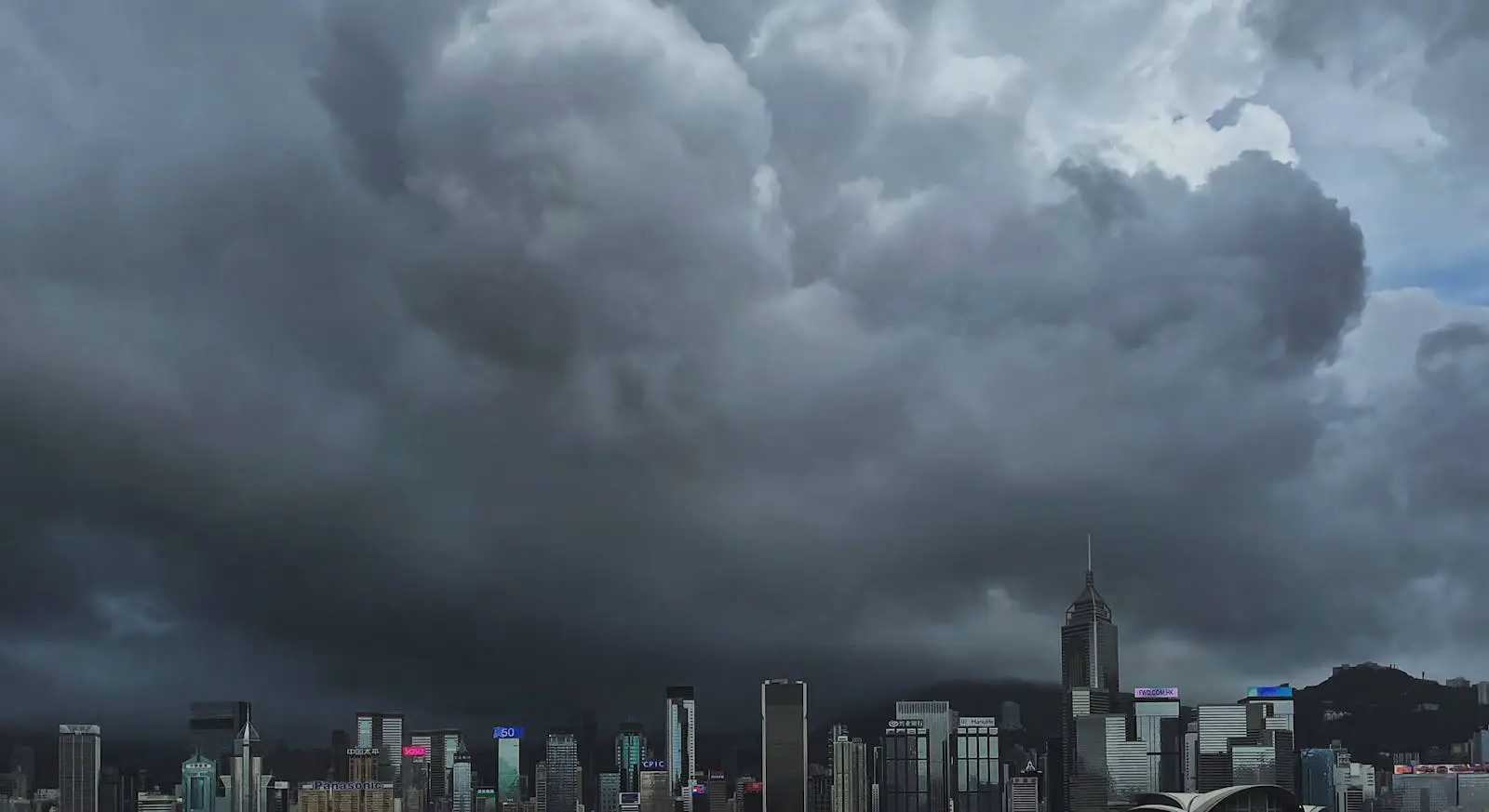 Dark storm clouds looming over the Hong Kong skyline before a typhoon.