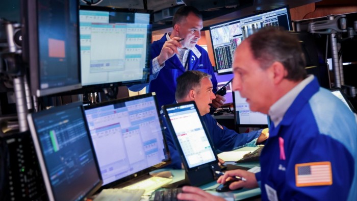 Traders work on the floor of the New York Stock Exchange