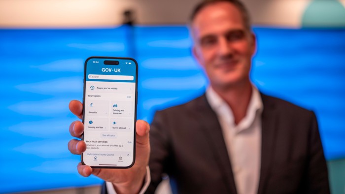 Technology secretary Peter Kyle shows off the new mobile app for government services