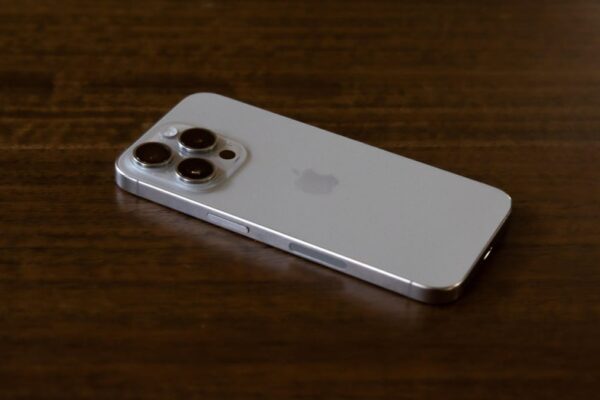 Purple iPhone 14 Pro face down on a red patterned pillow
