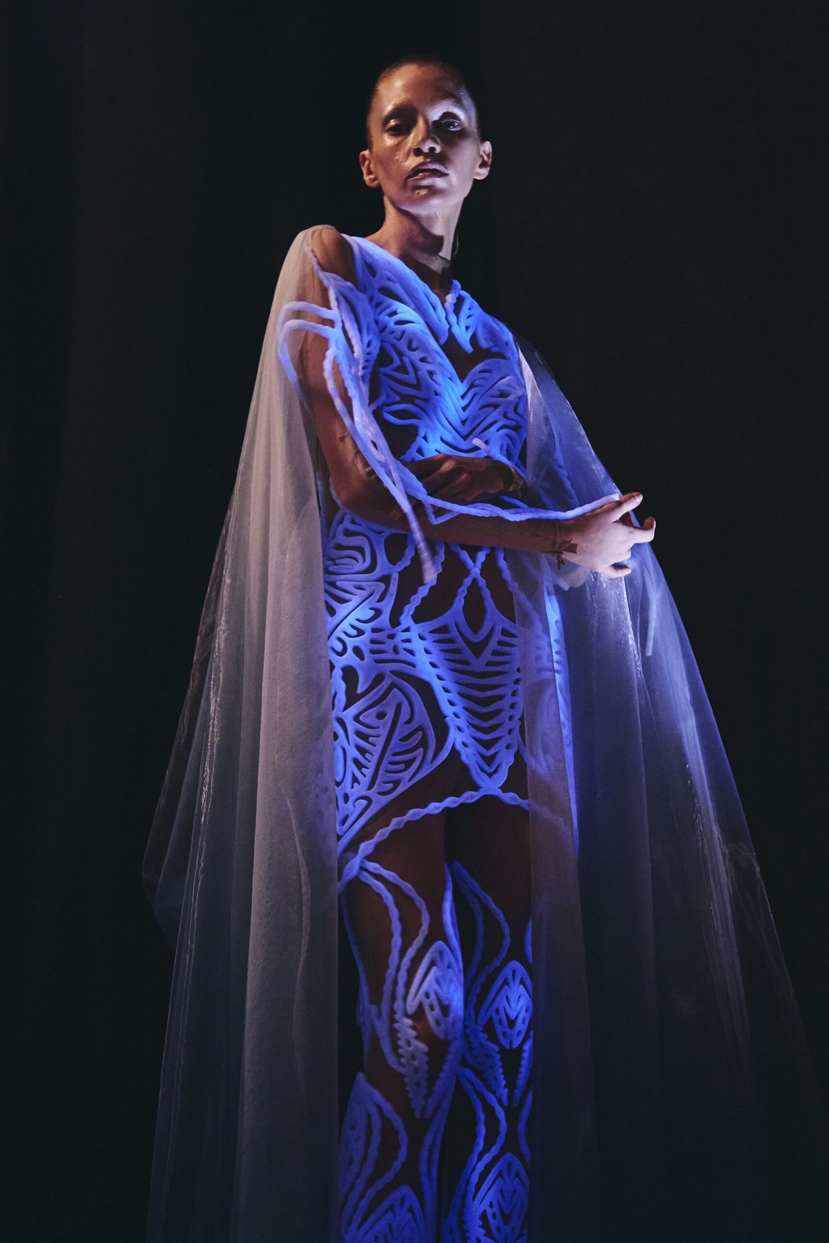 Bioluminescent dress glows with 125 million living algae at fashion show