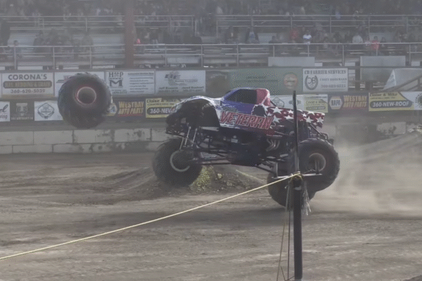 Video shows monster truck wheel fly off mid-performance, damaging multiple cars