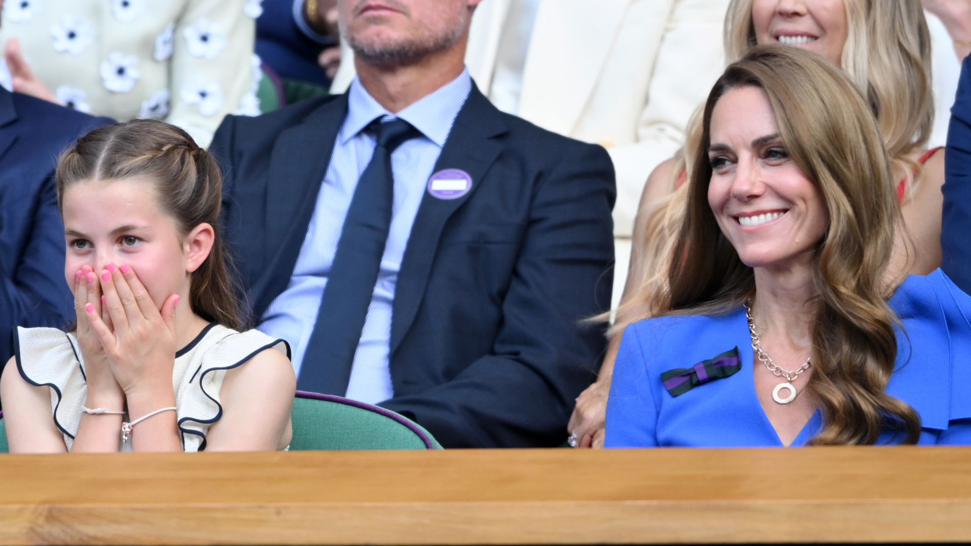 Princess Charlotte wearing pink nail polish at Wimbledon with her hands over her mouth