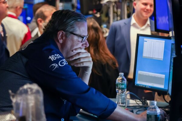 Wall Street closes down as investors brace for Powell's speech