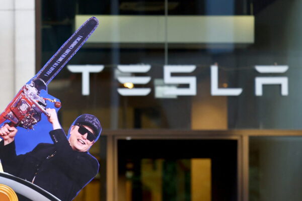 Activists of the "New Generation" (Neue Generation) and Extinction Rebellion protest in front of a Tesla store in Berlin