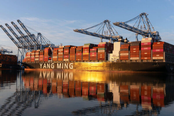 he sun rises over container ships docked at the Port of Tacoma's Husky Terminal in Tacoma, Washington