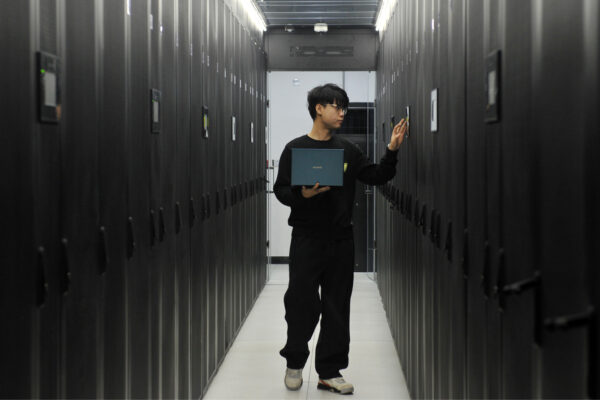 Chinese man working in a datacenter.