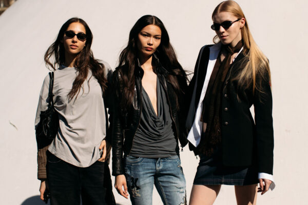 Attendees at paris fashion week fall 2025 standing in front of beige wall
