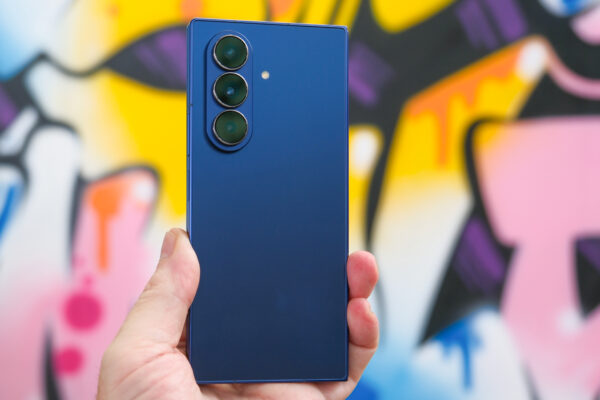 Samsung Galaxy Z Fold 7 in blue closed from the back with graffiti on the wall behind