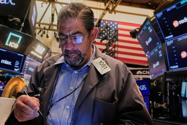 Trader Robert Oswald works on the floor of the New York Stock Exchange, Thursday, Aug. 14, 2025. (AP Photo/Richard Drew)
