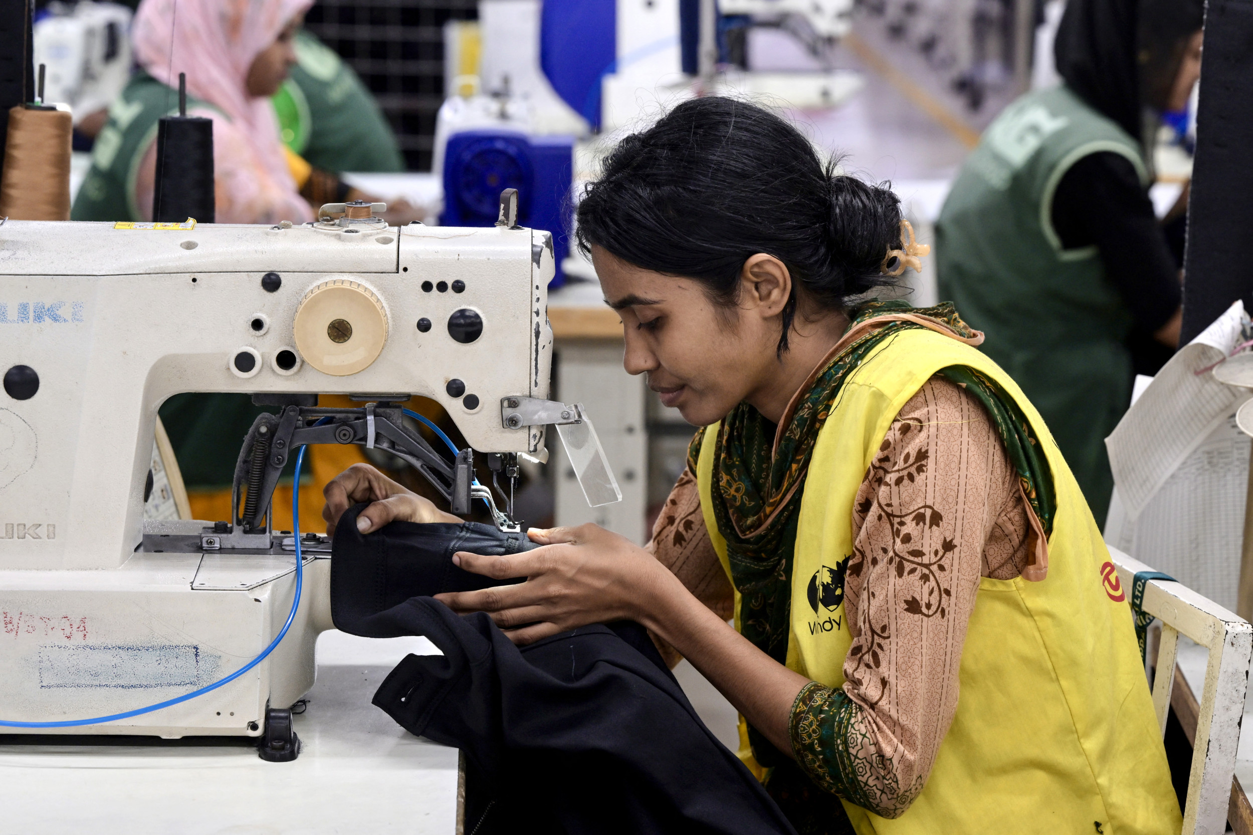 A garment worker tailors a cloth