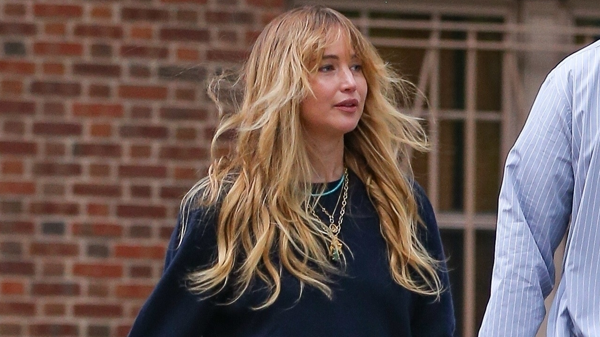 Jennifer Lawrence styled a navy sweater with her favorite skirt-pants and a Dior bowling bag