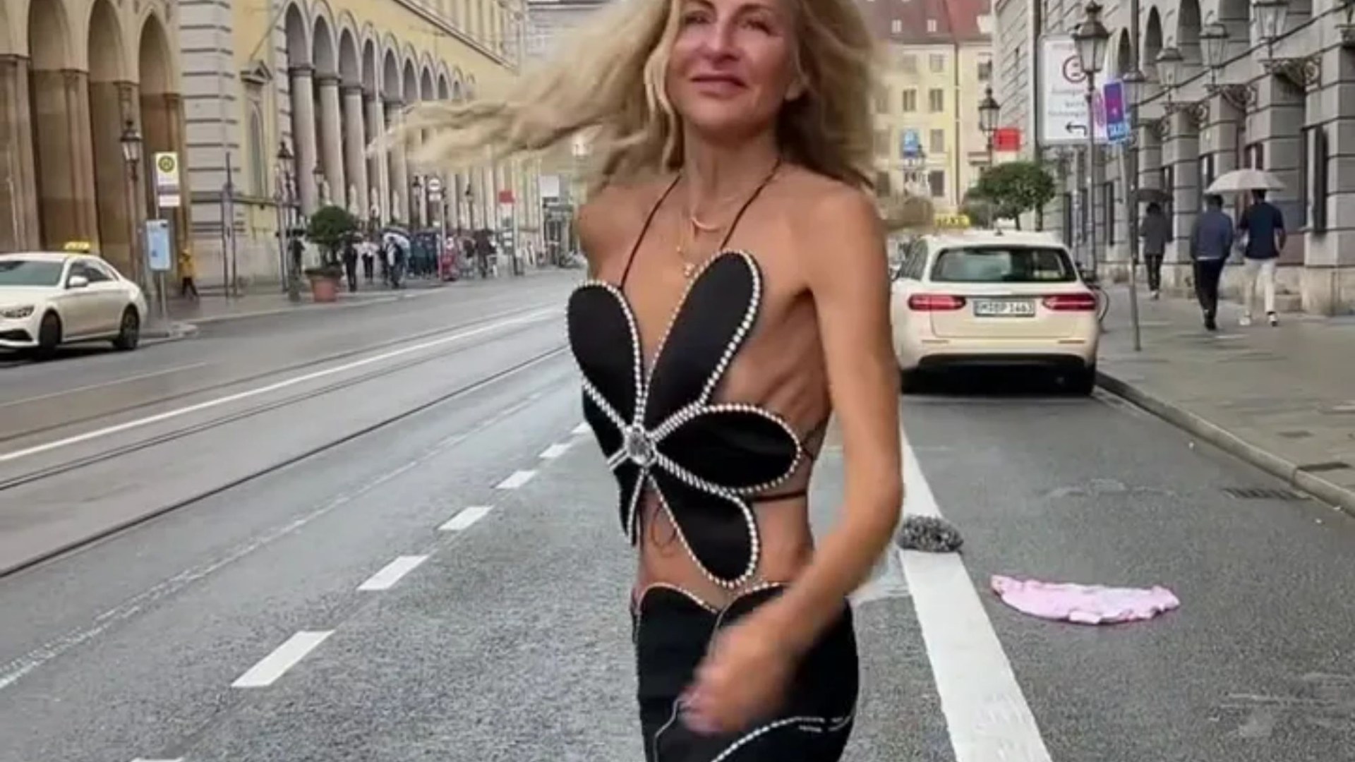 Woman shocks in extremely skimpy two-piece outfit & stunning long legs - but you’ll never guess her age