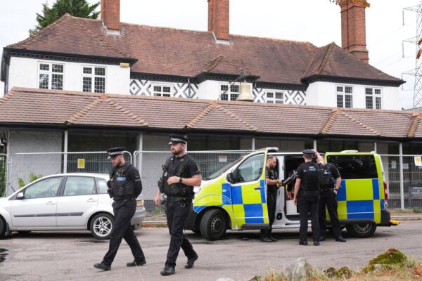Police outside the Bell Hotel in Epping on Friday. Pic: PA