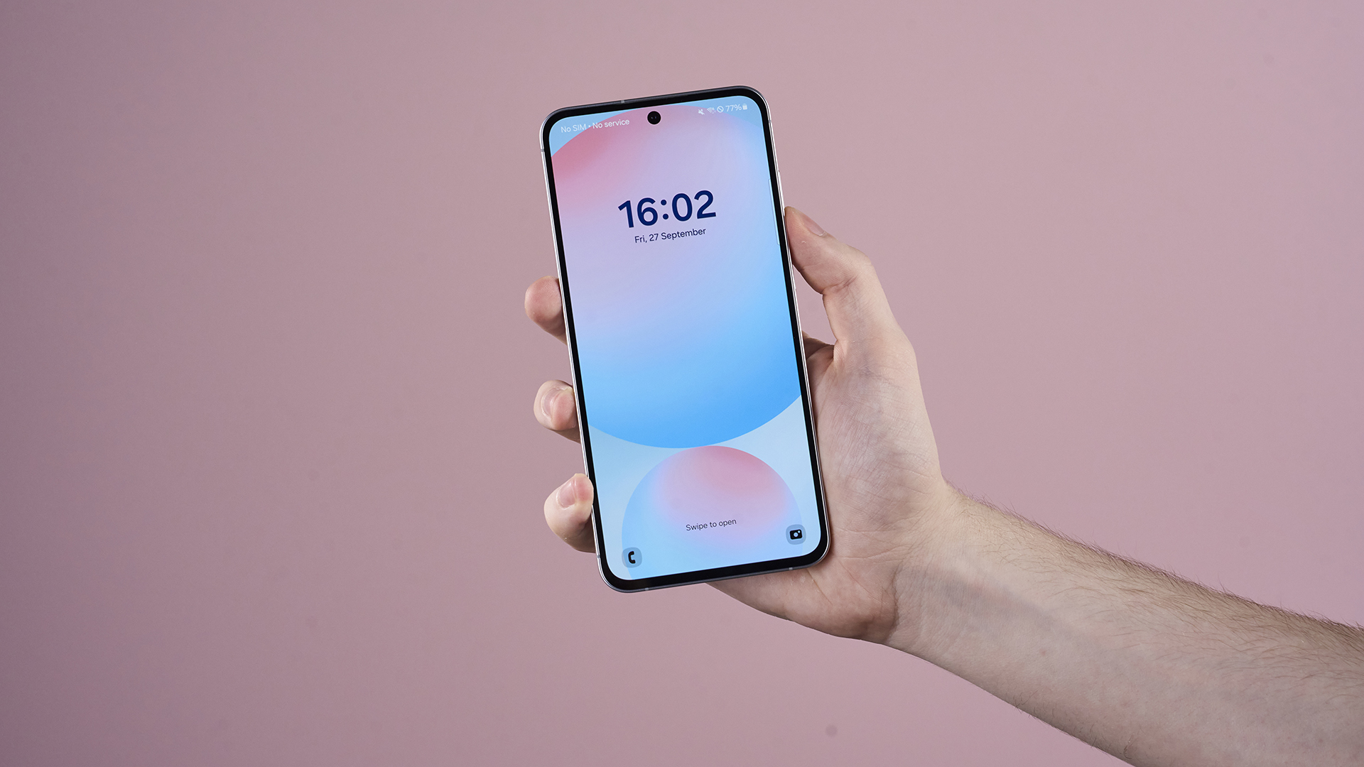 Samsung Galaxy S24 FE held in someone's hand with display showing the time