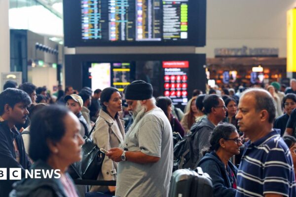 A picture of a check-in area at Heathrow Airport on Saturday morning, filled with busy rows of people queuing up.