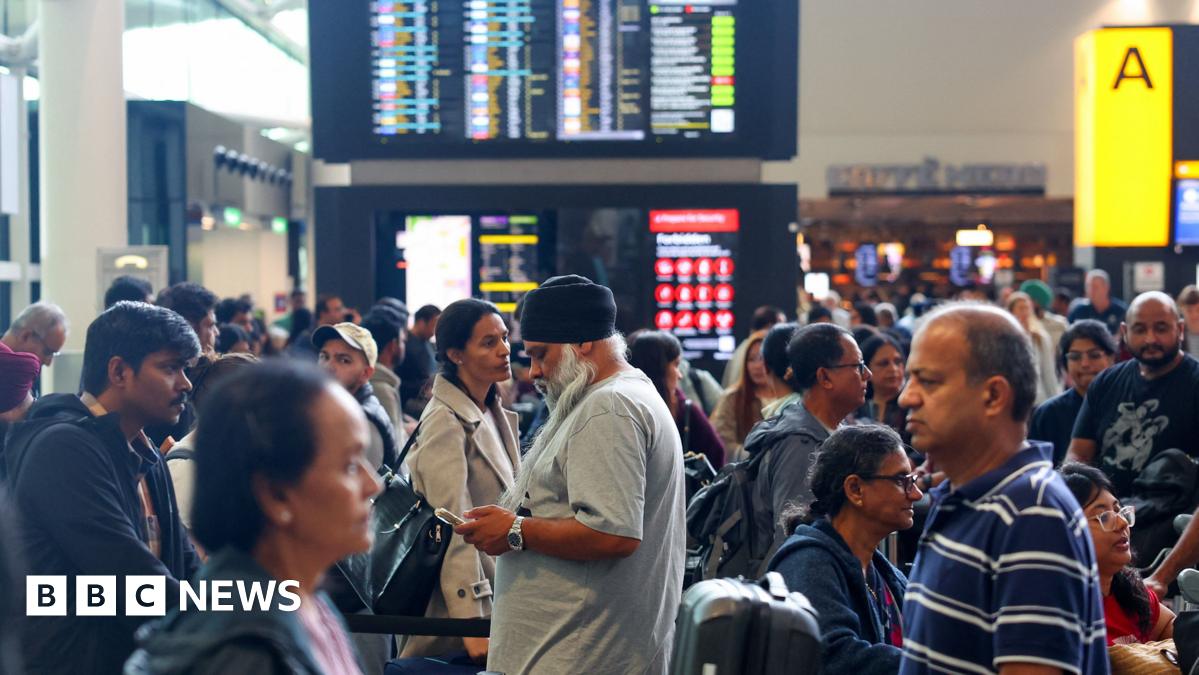 A picture of a check-in area at Heathrow Airport on Saturday morning, filled with busy rows of people queuing up.