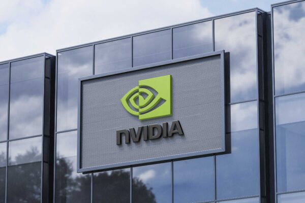 NVIDIA corporate building featuring bold 3D red NVIDIA logo under bright blue sky, symbolizing innovation and electric vehicle dominance in the global stock market