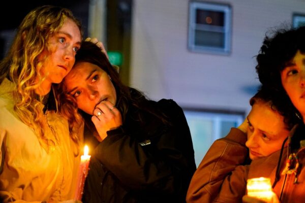People linger after a vigil for the victims of Wednesday's mass shootings, Oct. 29, 2023, outside the Basilica of Saints Peter and Paul in Lewiston, Maine. (AP Photo/Matt Rourke, File)
