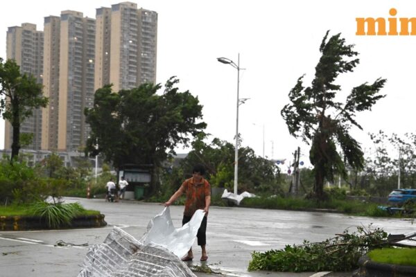 A woman clears debris after the passing of Typhoon Ragasa in Yangjiang, southern China’s Guangdong province on September 24, 2025.