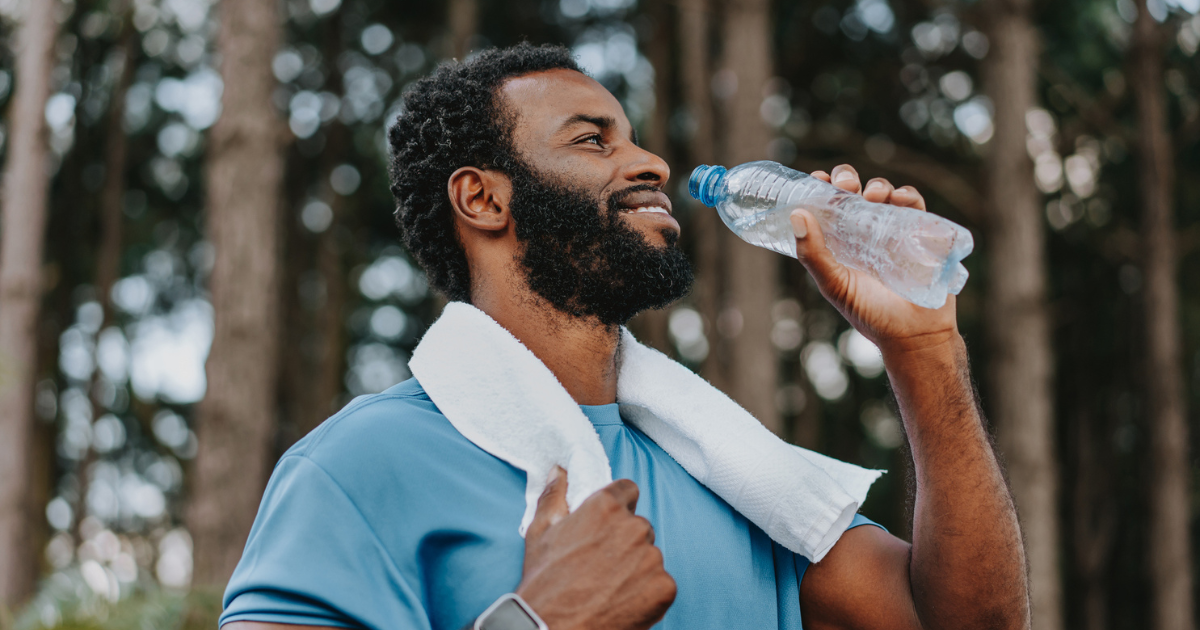 Man drinking from a plastic water bottle