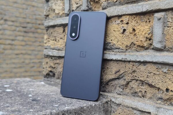 The OnePlus Nord 5 against a brick wall.
