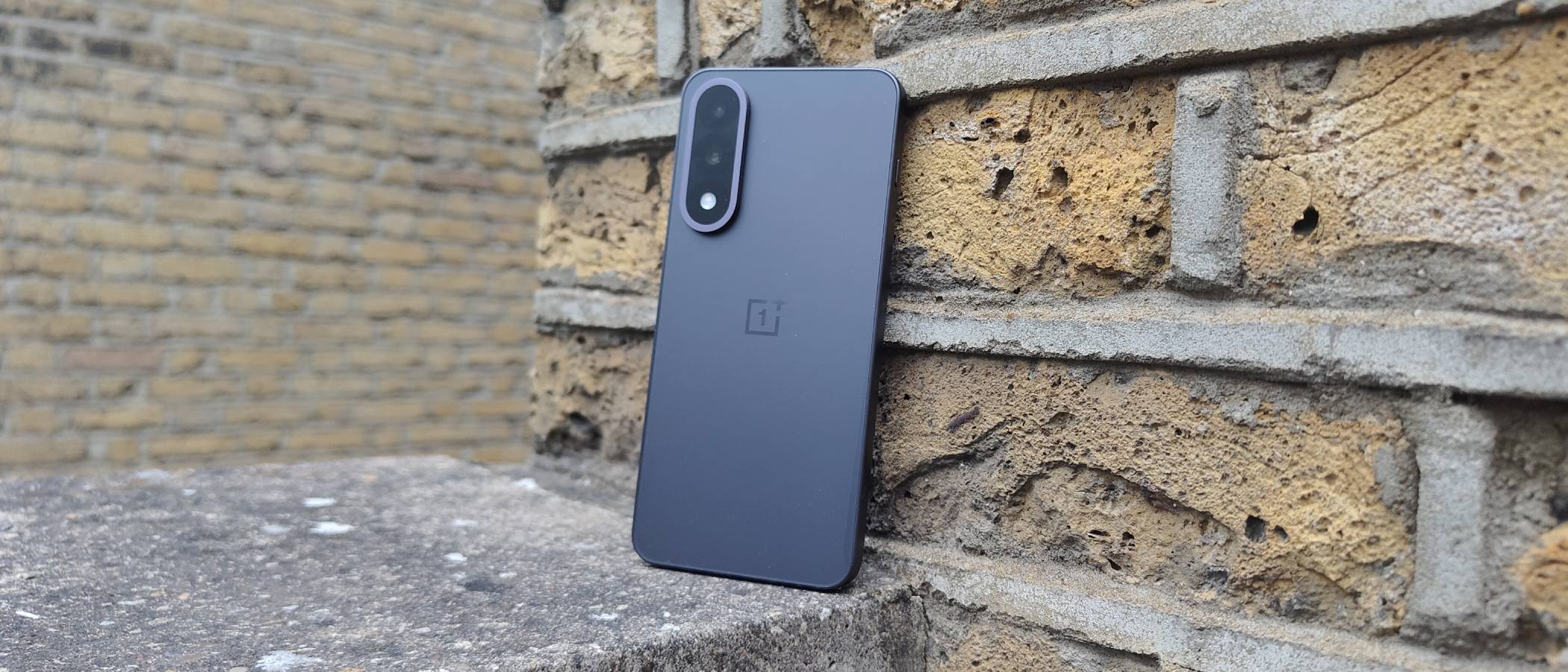 The OnePlus Nord 5 against a brick wall.