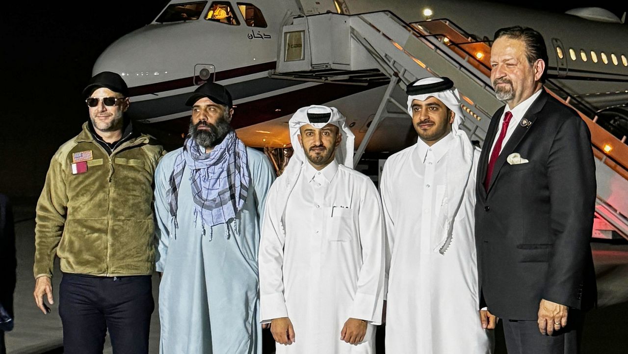 In this photo released by Qatar's Foreign Ministry, U.S. citizen Amir Amiri, second from left, poses before boarding a plane in Kabul, Afghanistan, on Sunday, Sept. 28, 2025, after being released from an Afghan prison. With him, from right, Deputy Assistant to the U.S. President Sebastian Gorka, an unidentified Qatari diplomat, Charge d'Affaires of the Embassy of the State of Qatar in Afghanistan Dr. Mirdef Al Qashouti, centre, and, left, U.S. Special Envoy for Hostage Response Adam Boehler. (Qatar Foreign Ministry via AP)