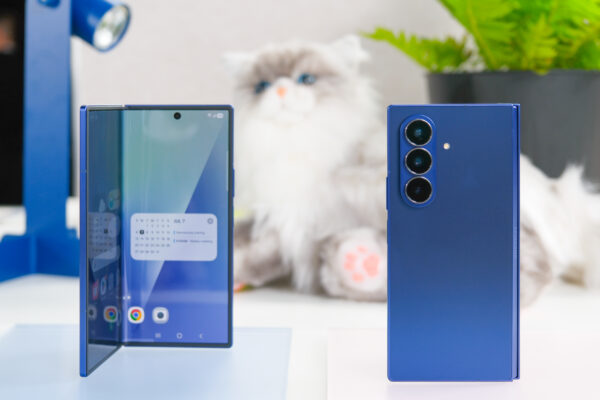 Two blue Samsung Galaxy Z Fold 7 devices with a stuffed cat behind them