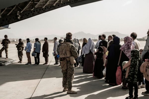 Evacuees wait to board a Boeing C-17 Globemaster III during an evacuation at Hamid Karzai International Airport in Kabul, Afghanistan, on Aug. 30. 2021. (Staff Sgt. Victor Mancilla/U.S. Marine Corps via AP)