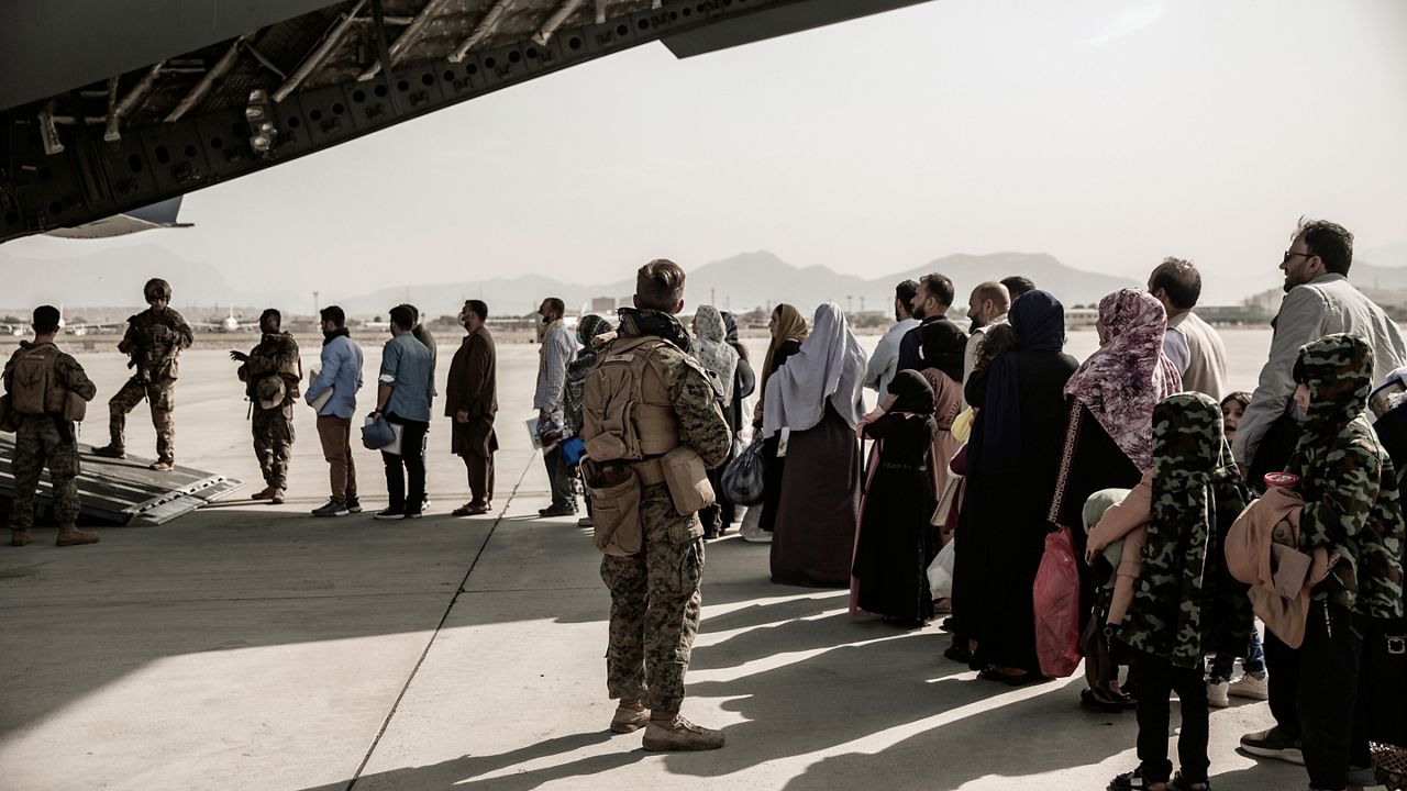 Evacuees wait to board a Boeing C-17 Globemaster III during an evacuation at Hamid Karzai International Airport in Kabul, Afghanistan, on Aug. 30. 2021. (Staff Sgt. Victor Mancilla/U.S. Marine Corps via AP)