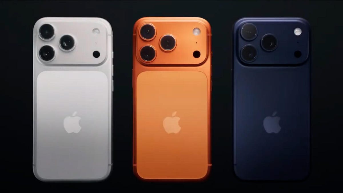 Three of the same iPhone from the back in silver, orange and blue colors.