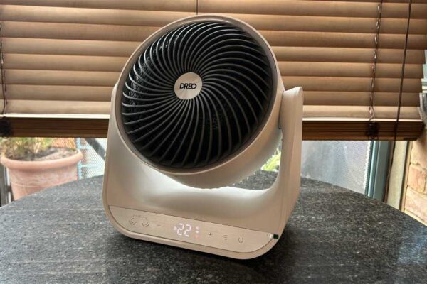 Dreo heater on a table, in front of a window