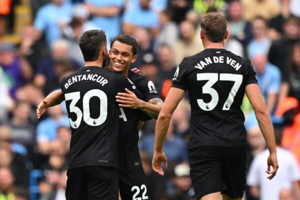 Brennan Johnson of Tottenham Hotspur hugs his teammates during a game.