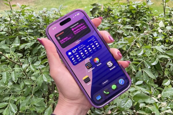 iPhone 16 Pro in hand, dark mode