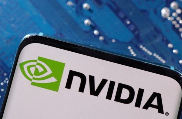 A smartphone displaying the Nvidia logo rests on top of a computer motherboard.