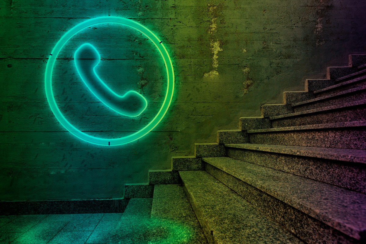 Telephone sign on concrete wall.