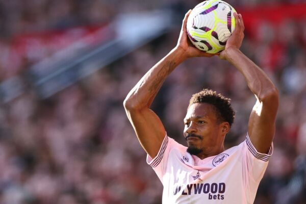 Ethan Pinnock of Brentford takes a throw in during the Premier League match between Manchester United FC and Brentford FC at Old Trafford