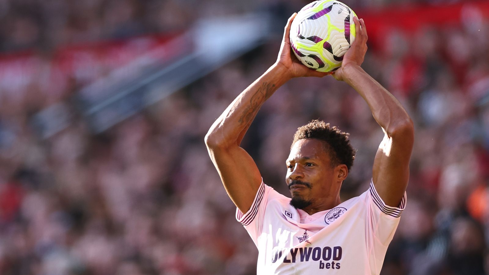 Ethan Pinnock of Brentford takes a throw in during the Premier League match between Manchester United FC and Brentford FC at Old Trafford