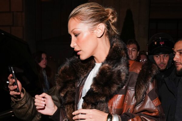 Bella Hadid wearing a patchwork jacket with a vintage Dior bag
