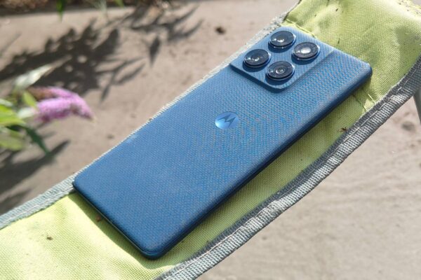 The Motorola Edge 60 on the arm of a chair.